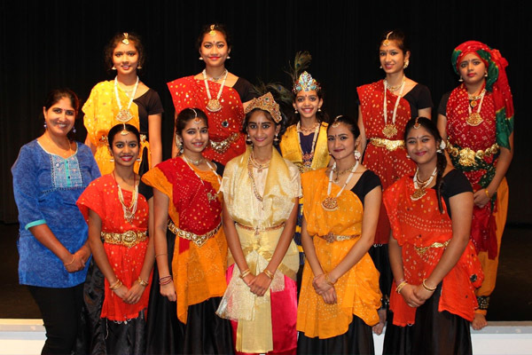 Aarushi dressed as kid Krishna with dancers as Gopikas