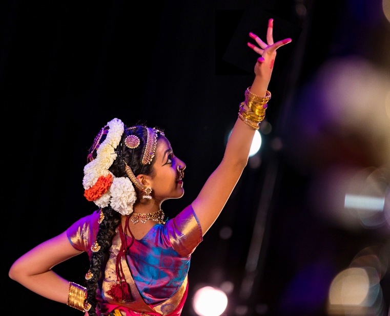 Aarushi Lakhi dancing from behind in a pink and blue Bharatanatyam costume