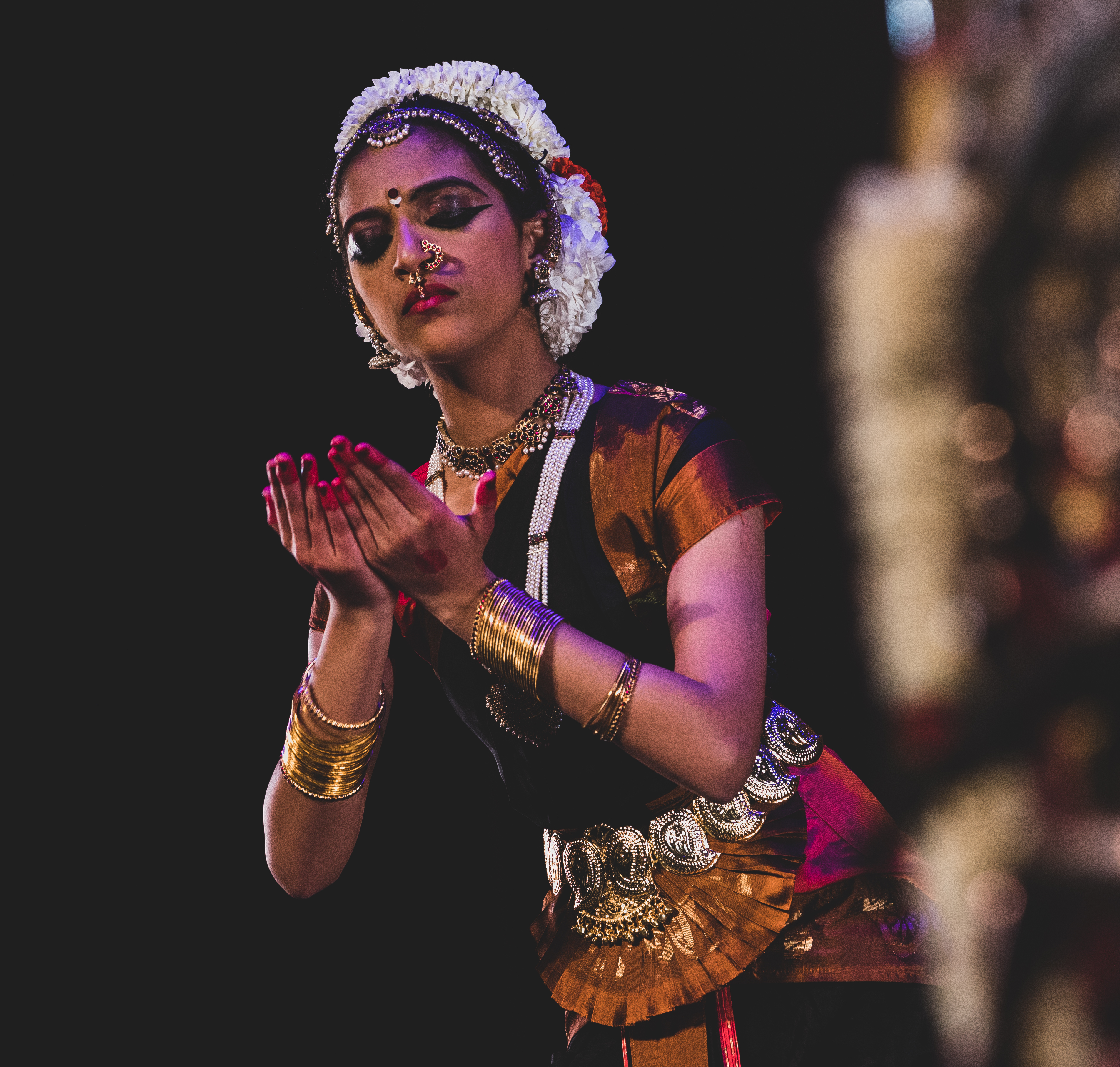 Aarushi Lakhi in a black and pink Bharatanatyam costume showing a book